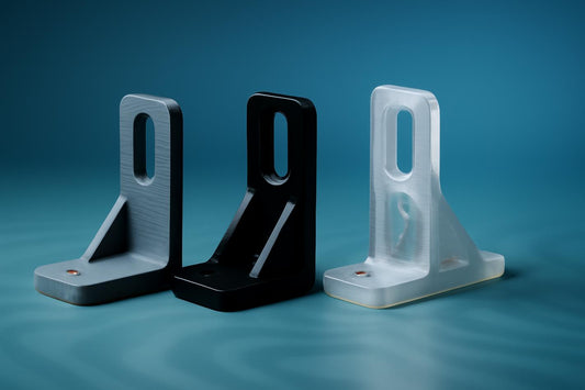 Prototype bracket iterations in gray, black, and translucent blue, showcasing design evolution.